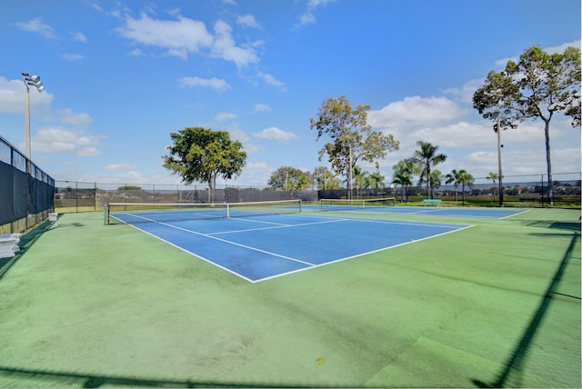 view of tennis court featuring fence