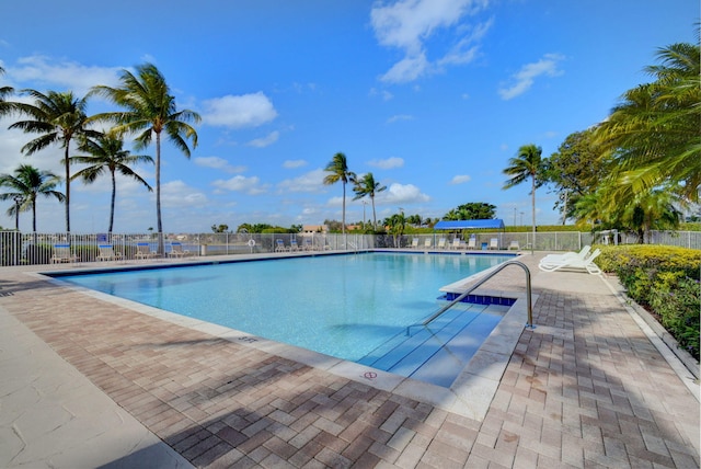 pool with fence and a patio area