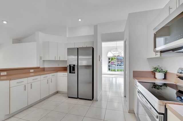 kitchen featuring light countertops, appliances with stainless steel finishes, light tile patterned floors, and white cabinetry