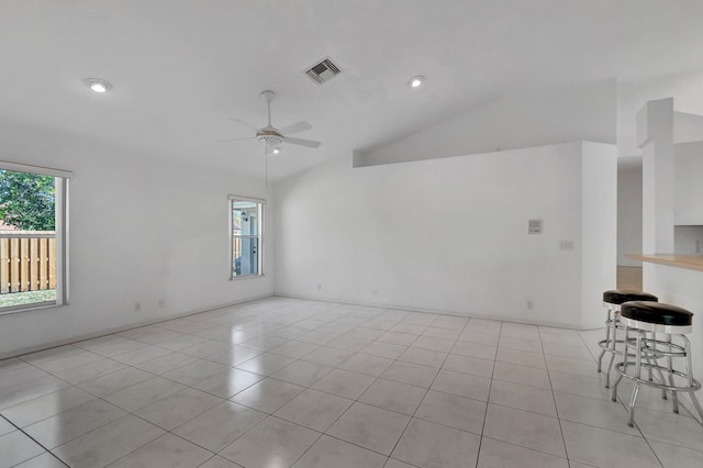 unfurnished room with light tile patterned flooring, ceiling fan, recessed lighting, vaulted ceiling, and visible vents