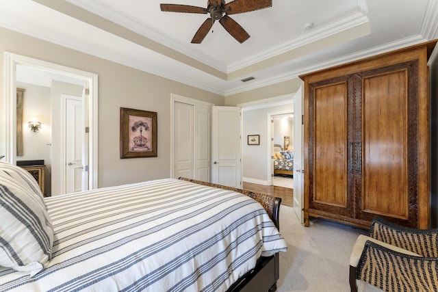 bedroom with ornamental molding, a ceiling fan, and visible vents