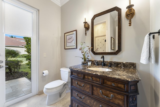bathroom with crown molding, toilet, and vanity