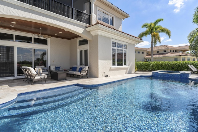 view of pool with a pool with connected hot tub, an outdoor living space, a ceiling fan, and a patio area