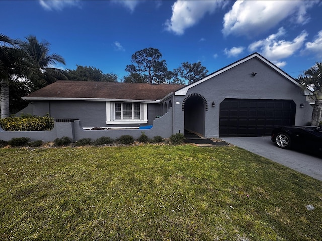 ranch-style house featuring a garage, a front lawn, stucco siding, and driveway