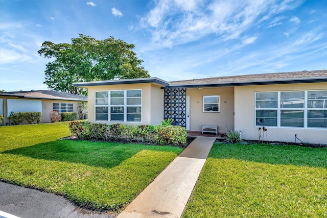 955 Circle A Dr Unit A, Delray Beach, FL 33445 - view of front of house with stucco siding and a front lawn