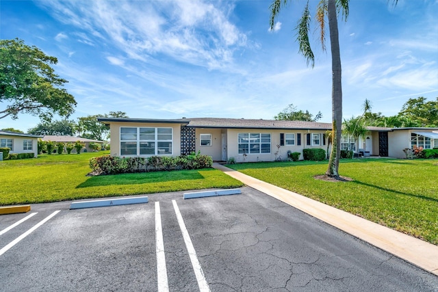 955 Circle A Dr Unit A, Delray Beach, FL 33445 - single story home featuring uncovered parking, a front lawn, and stucco siding