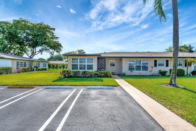 955 Circle A Dr Unit A, Delray Beach, FL 33445 - ranch-style house featuring stucco siding, uncovered parking, and a front lawn