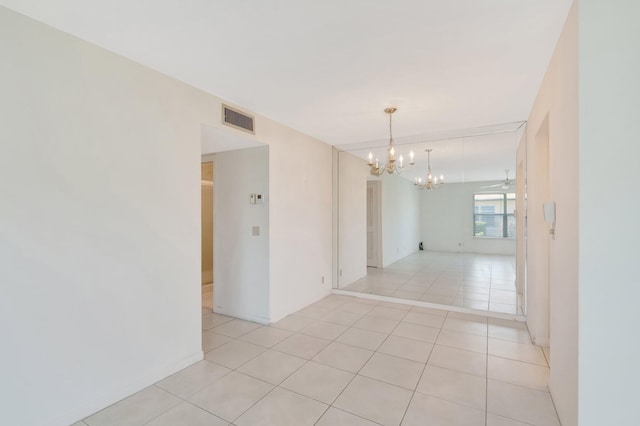 955 Circle A Dr Unit A, Delray Beach, FL 33445 - empty room featuring a chandelier and light tile patterned floors