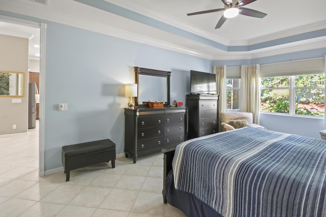 bedroom featuring light tile patterned flooring, a raised ceiling, freestanding refrigerator, baseboards, and ornamental molding