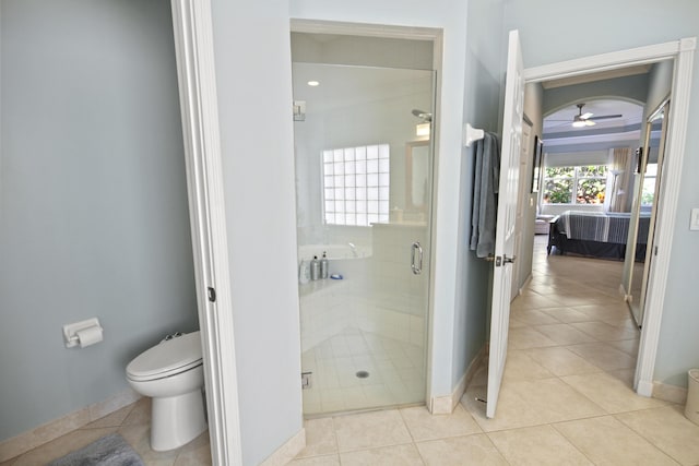 full bathroom featuring tile patterned flooring, toilet, ensuite bathroom, baseboards, and a stall shower
