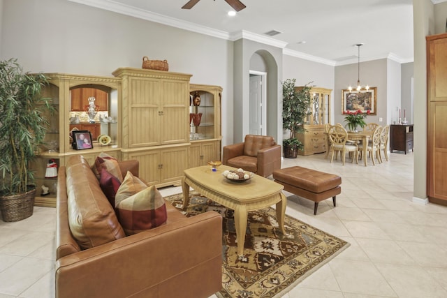 living area with visible vents, crown molding, arched walkways, ceiling fan with notable chandelier, and light tile patterned flooring