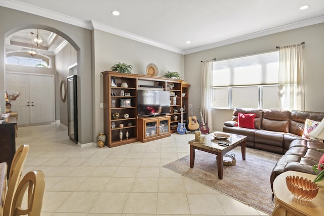living area with arched walkways, recessed lighting, baseboards, light tile patterned floors, and ornamental molding