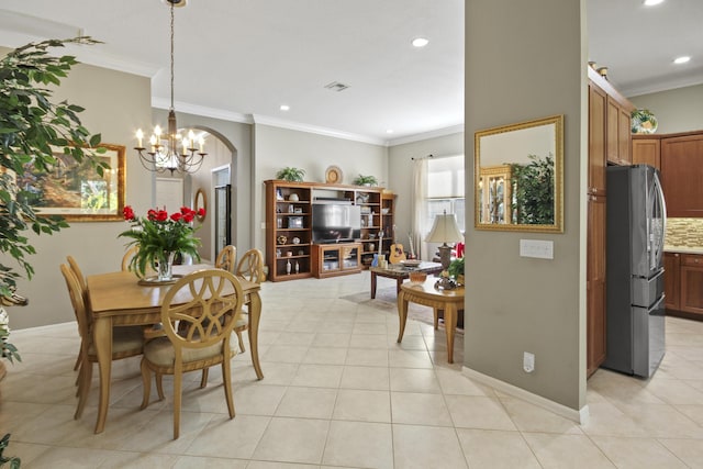 dining space featuring crown molding, arched walkways, light tile patterned floors, an inviting chandelier, and recessed lighting