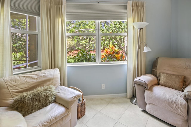 living area with tile patterned floors and baseboards