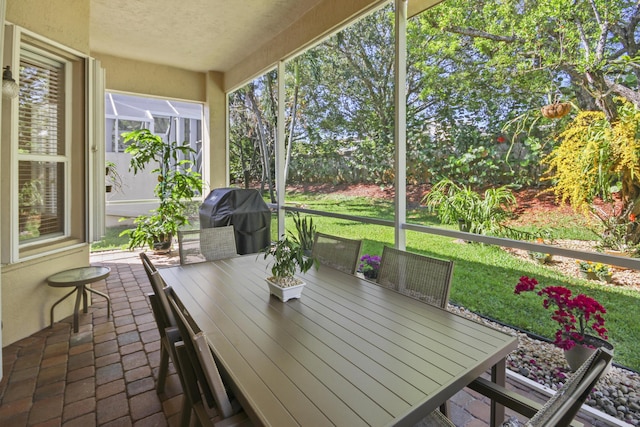 unfurnished sunroom featuring outdoor dining space