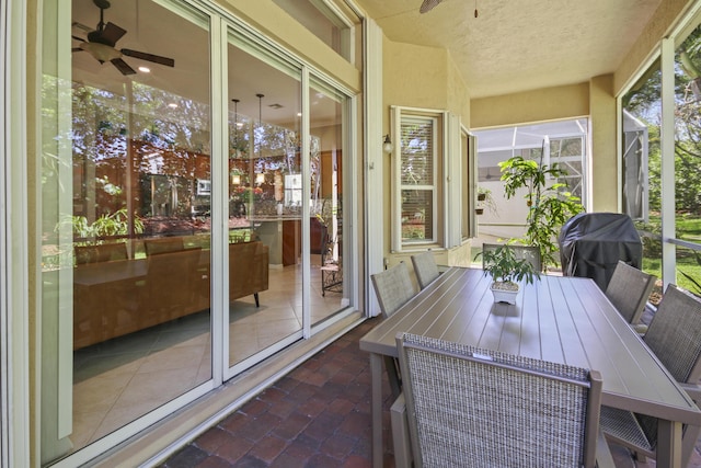 sunroom / solarium featuring ceiling fan
