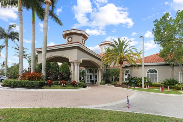 view of building exterior with curved driveway