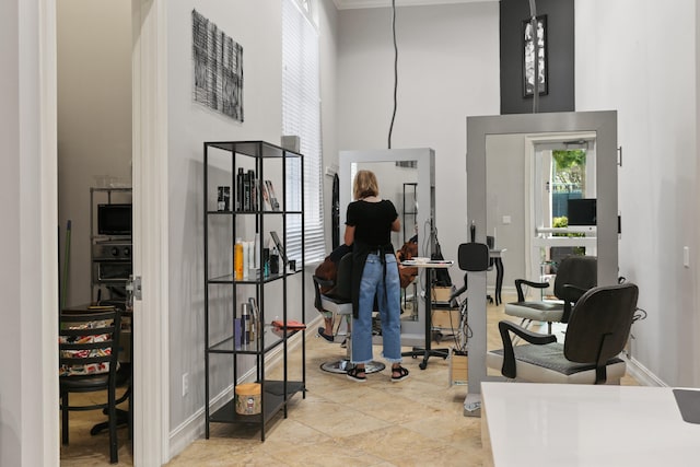 interior space featuring baseboards and a towering ceiling