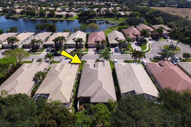 drone / aerial view with a residential view and a water view