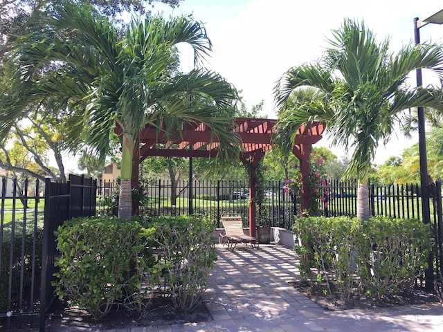 880 Cypress Park Way Unit E, Deerfield Beach, FL 33064 - view of property's community with fence, a patio, and a pergola