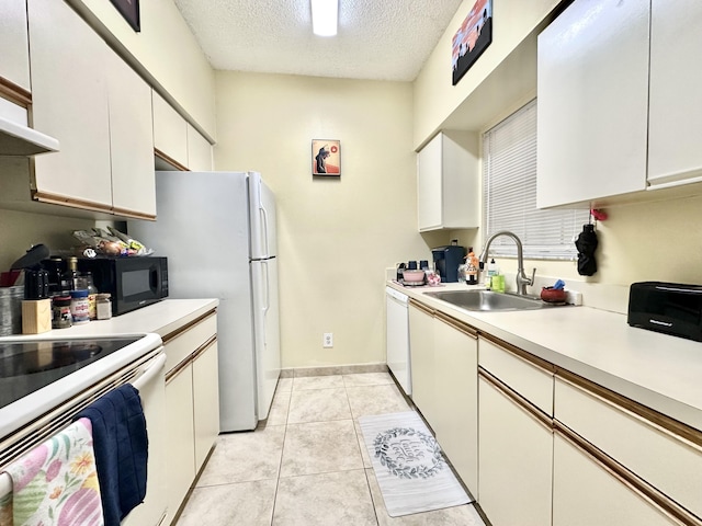 880 Cypress Park Way Unit E, Deerfield Beach, FL 33064 - kitchen featuring light countertops, white appliances, a sink, a textured ceiling, and white cabinetry