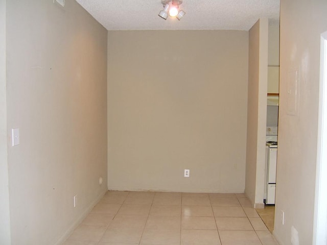 880 Cypress Park Way Unit E, Deerfield Beach, FL 33064 - empty room with a textured ceiling and light tile patterned floors
