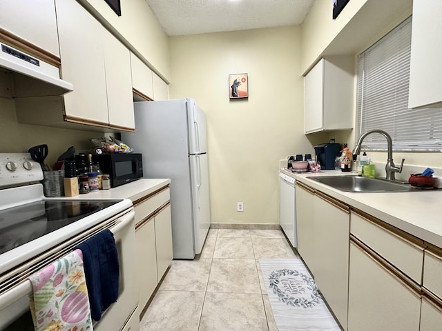 880 Cypress Park Way Unit E, Deerfield Beach, FL 33064 - kitchen with a sink, white appliances, light countertops, under cabinet range hood, and light tile patterned floors