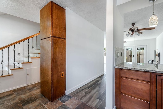 5606 Channel Dr, Lake Worth, FL 33463 - interior space featuring a textured ceiling, ceiling fan, stairway, and baseboards
