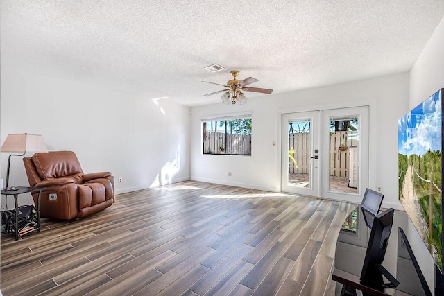 5606 Channel Dr, Lake Worth, FL 33463 - unfurnished room with a textured ceiling, visible vents, ceiling fan, and wood finished floors