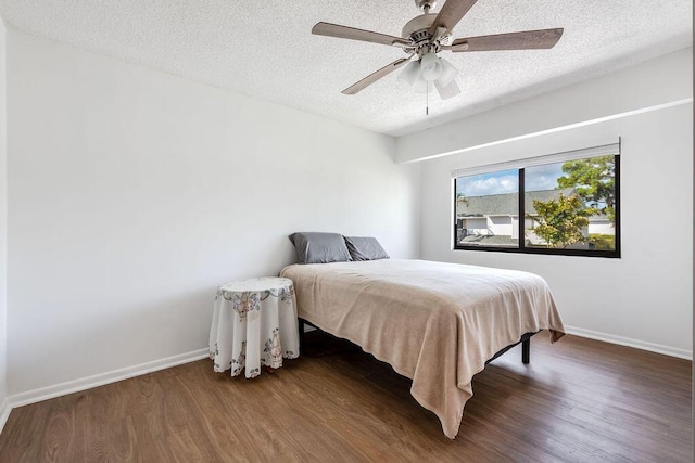 5606 Channel Dr, Lake Worth, FL 33463 - bedroom with a textured ceiling, a ceiling fan, wood finished floors, and baseboards