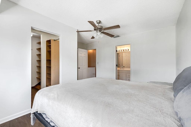 5606 Channel Dr, Lake Worth, FL 33463 - bedroom with a sink, a ceiling fan, a spacious closet, wood finished floors, and ensuite bathroom