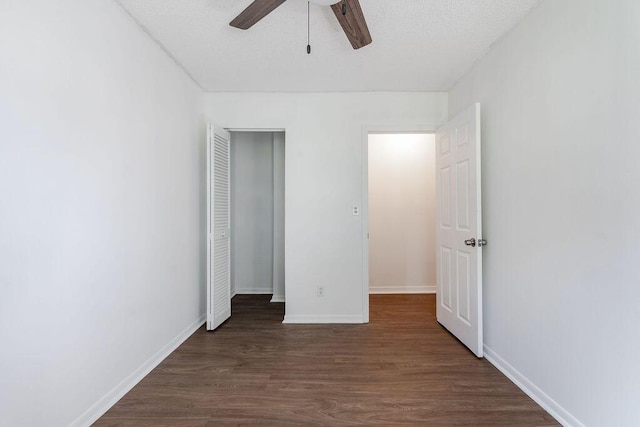 5606 Channel Dr, Lake Worth, FL 33463 - unfurnished bedroom with dark wood-style flooring, baseboards, a ceiling fan, and a closet