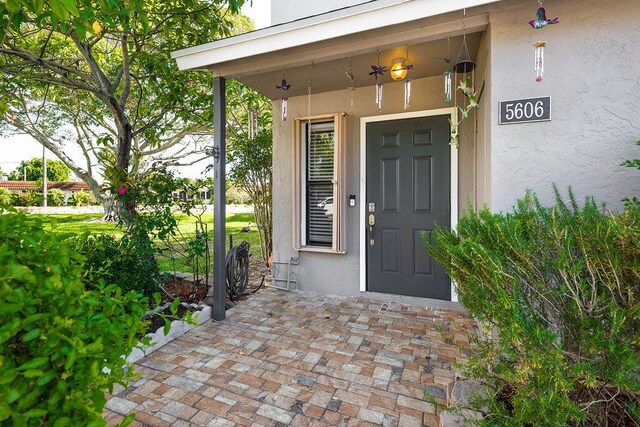 5606 Channel Dr, Lake Worth, FL 33463 - doorway to property featuring stucco siding