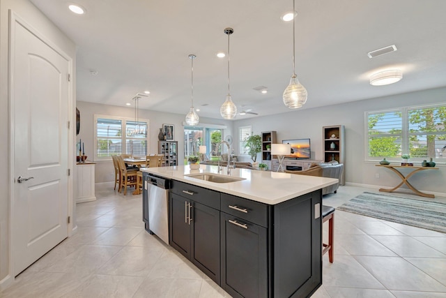 kitchen featuring a sink, light countertops, open floor plan, stainless steel dishwasher, and visible vents