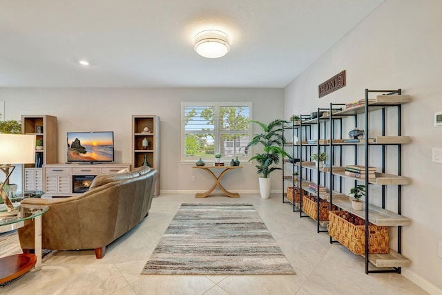 interior space with baseboards and a glass covered fireplace