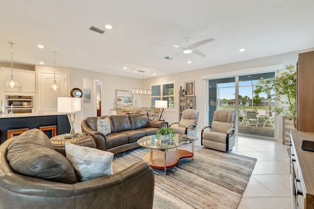 living room with visible vents, a ceiling fan, light tile patterned flooring, and recessed lighting