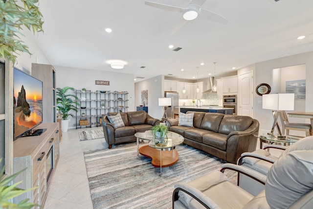 living room featuring recessed lighting, ceiling fan, and visible vents