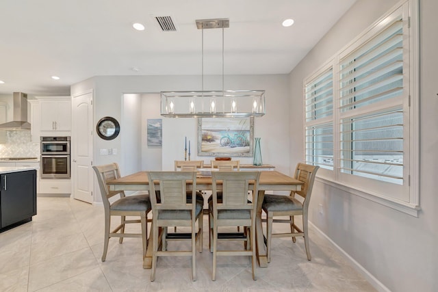 13339 SW Gingerline Dr, Port Saint Lucie, FL 34987 - dining space featuring a chandelier, light tile patterned flooring, recessed lighting, and baseboards