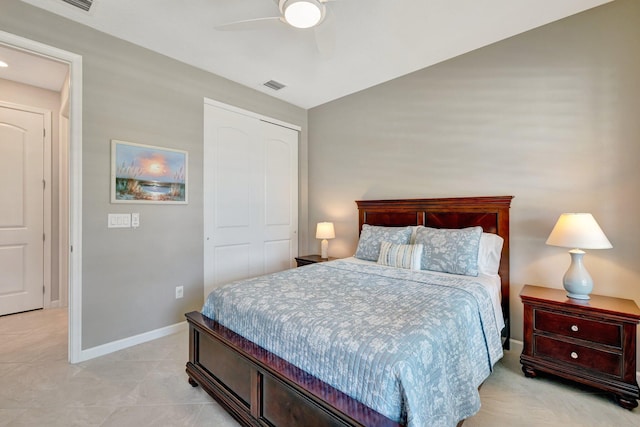 bedroom featuring a ceiling fan, visible vents, baseboards, a closet, and light tile patterned flooring