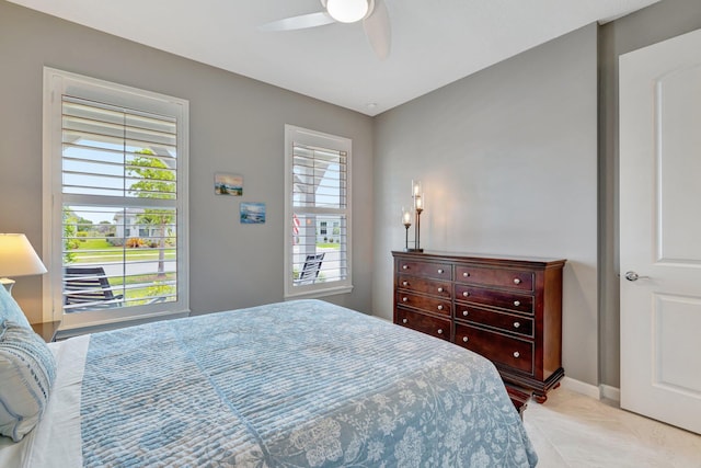 bedroom with baseboards and a ceiling fan