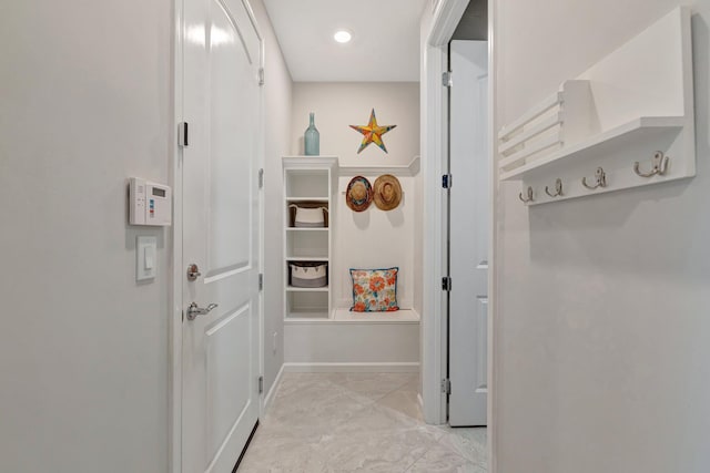 corridor with recessed lighting and baseboards