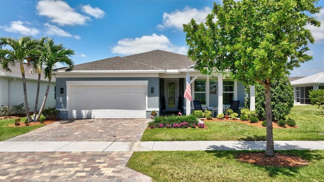 ranch-style home featuring a garage, a front lawn, and stucco siding