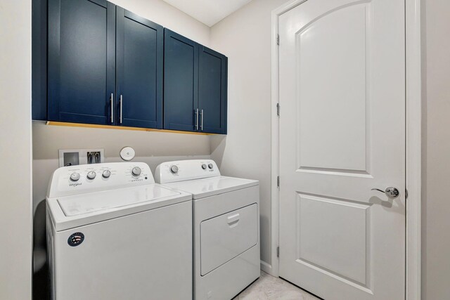13339 SW Gingerline Dr, Port Saint Lucie, FL 34987 - laundry area featuring independent washer and dryer and cabinet space