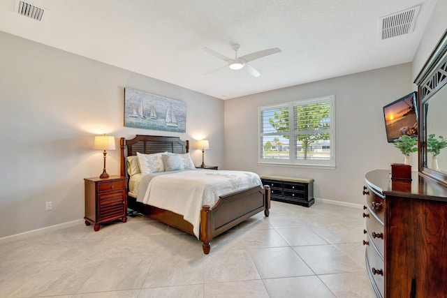 bedroom with a ceiling fan, baseboards, visible vents, and light tile patterned floors