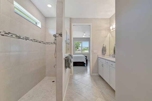 full bath with a walk in shower, ceiling fan, ensuite bath, tile patterned floors, and baseboards