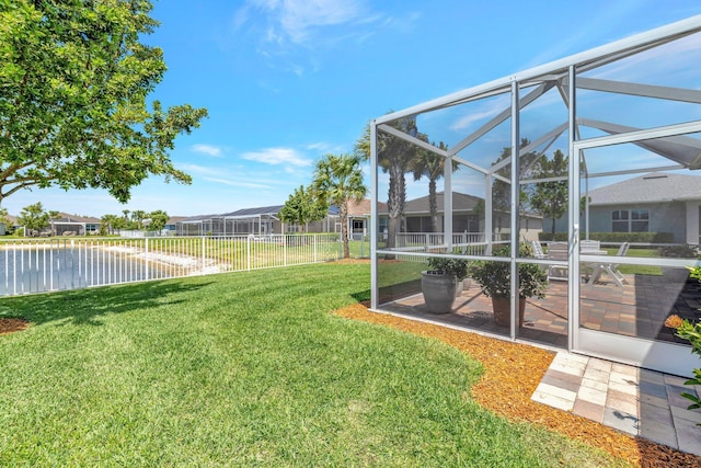 view of yard with a fenced backyard, a patio, a lanai, and a residential view