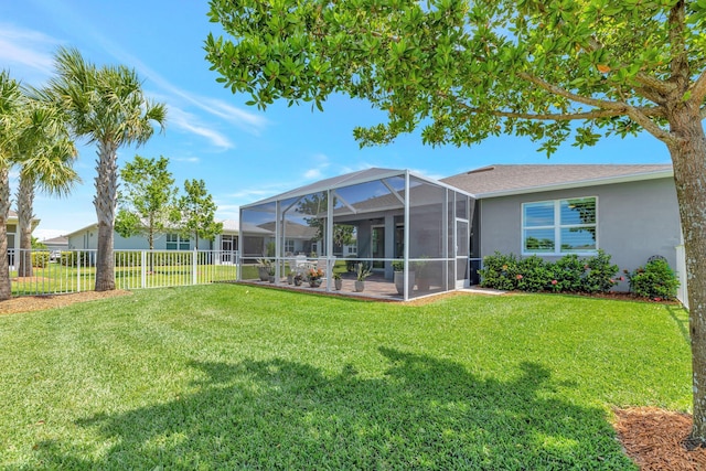 view of yard featuring a lanai, a patio area, and fence