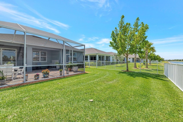 view of yard with a patio, a fenced backyard, and a lanai