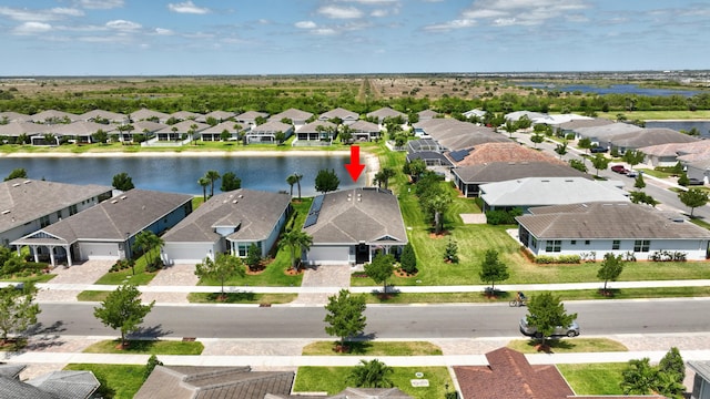 birds eye view of property with a residential view and a water view