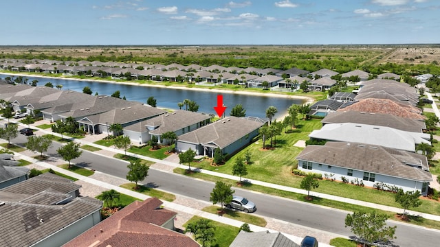 birds eye view of property featuring a water view and a residential view